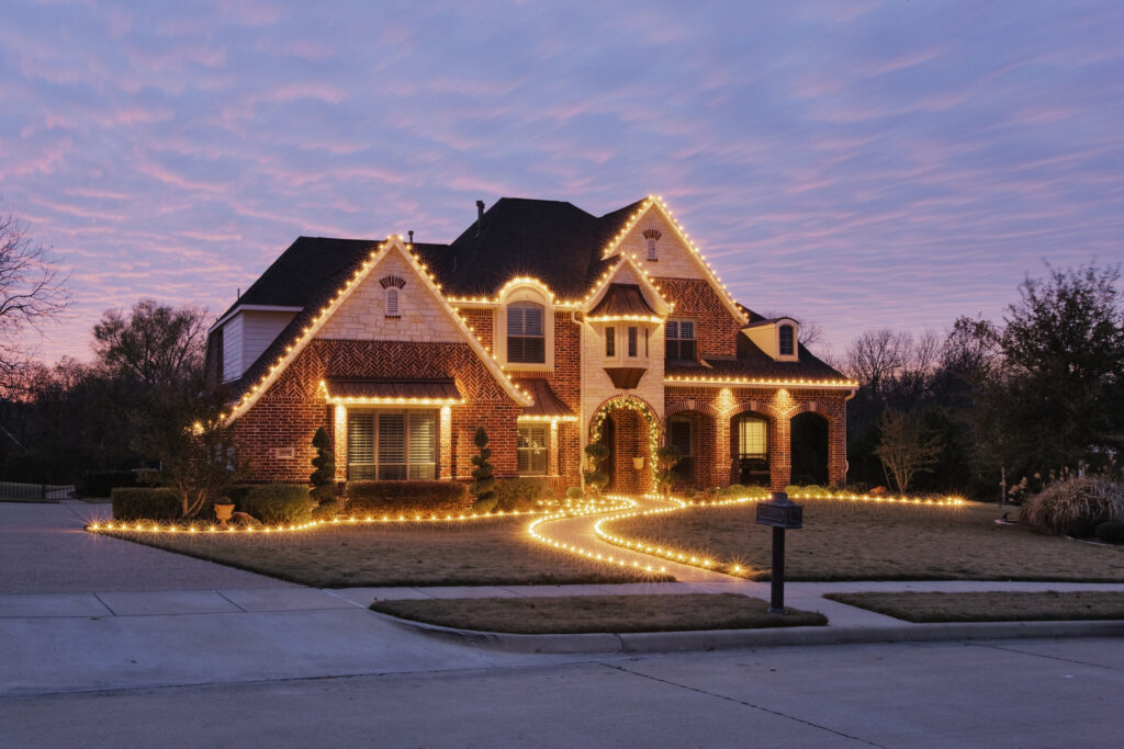 Christmas light installation in Texas, featuring festive decorations on homes and trees during the holiday season.