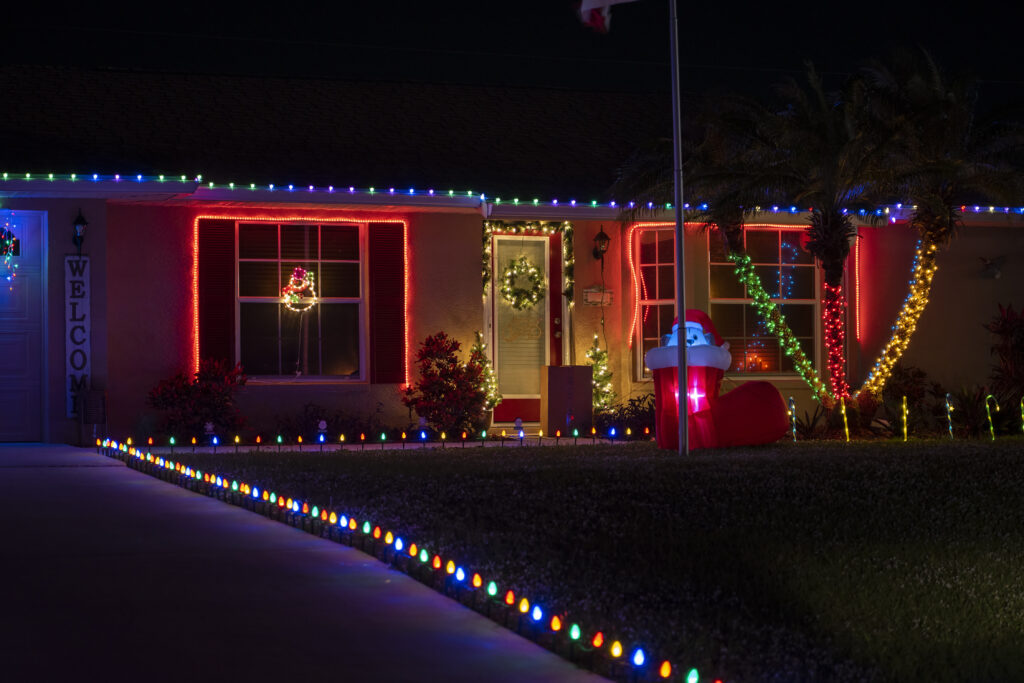 Christmas light installation in Texas, featuring festive decorations on homes and trees during the holiday season.