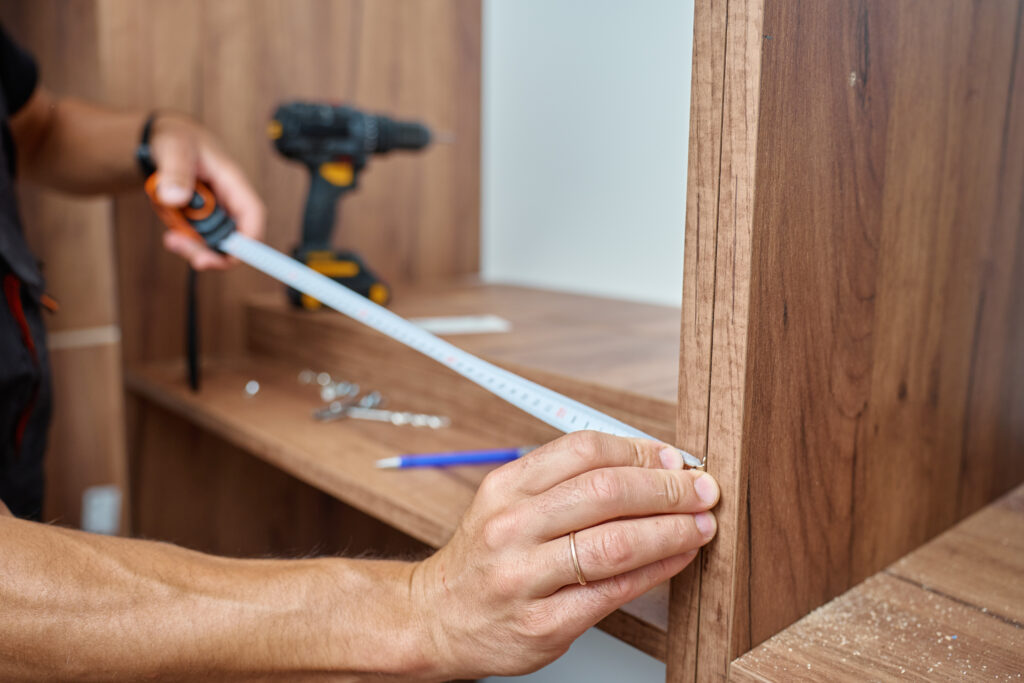 Expert performing cabinet hardware installation for kitchen cabinets