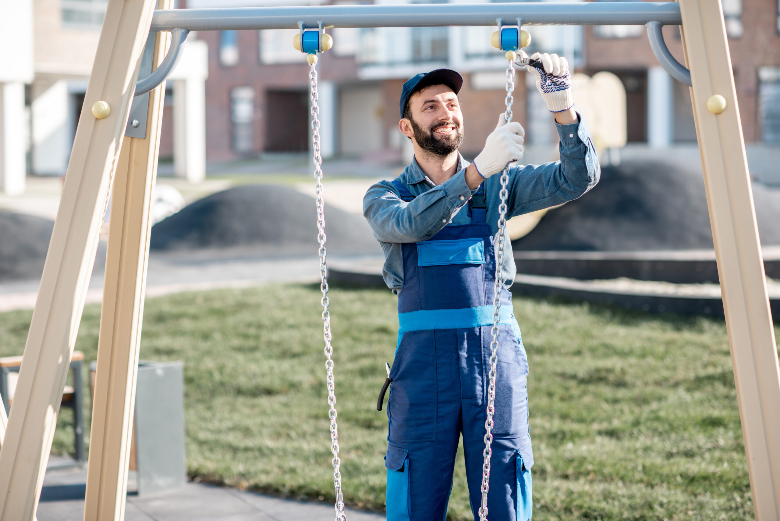 Technician installing a metal swing set at a residential playground – Swing Set & Playset Installation service