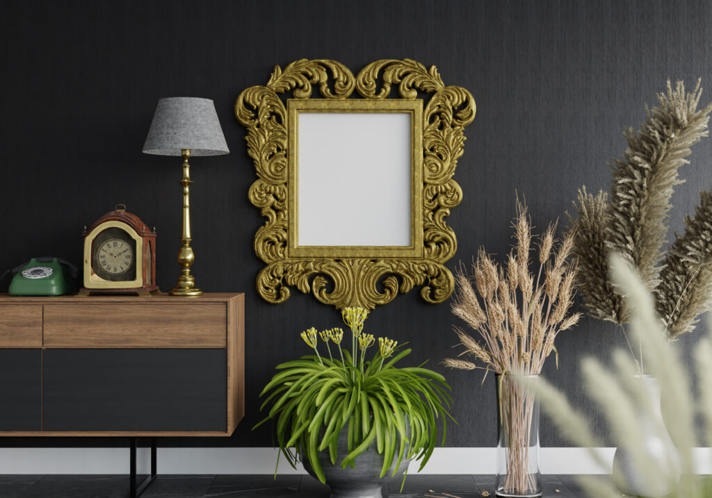 Classic vintage photo frame and wall art installation on a dark wall with lamps and decor items.